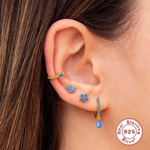 Three-piece 925 sterling silver earring set with gold plating and blue gemstones