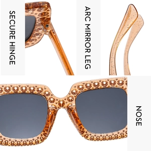 Detail view of amber square rhinestone sunglasses with secure hinges and arc legs