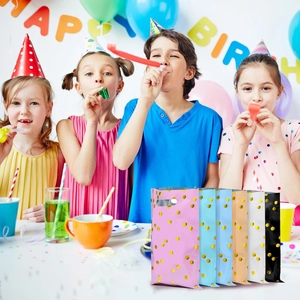 Colorful birthday gift bags with gold polka dots and handles for party favors