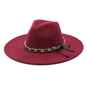Detail of burgundy wool fedora with 9.5cm wide brim and gold chain bow decoration