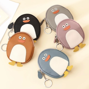 Detailed view of penguin-shaped leather coin purses in five colors with keychains