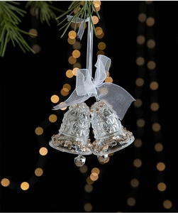 Macro detail of transparent acrylic Christmas double bells with sequins and a white bow