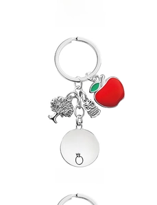 Detail of teacher keychain with apple, tree, owl charms and engraved heart message