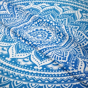 Close-up of bohemian mandala tapestry showing intricate navy blue and white fabric textures