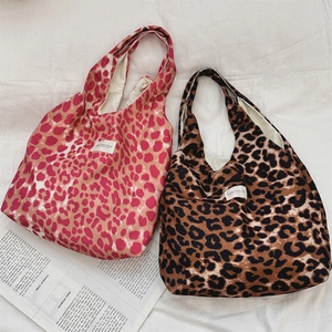 Detailed top view of large leopard print canvas tote bags with soft cream lining