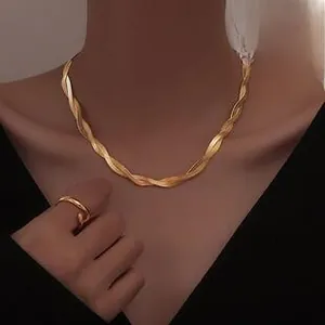 Close-up of golden multi-strand Cuban chain necklace and matching twisted ring set