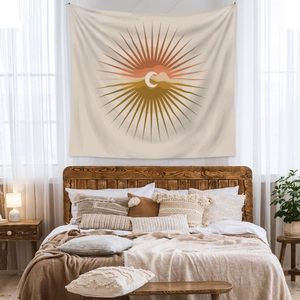 Detail view of Bohemian sun and moon tapestry on bedroom wall with warm earth tones