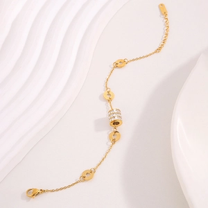 Detailed macro view of the gold plated cylinder pendant with white cubic zirconia inlay