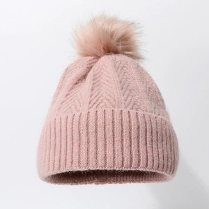 Pink knit beanie for women with pompom featuring thick herringbone texture for winter warmth