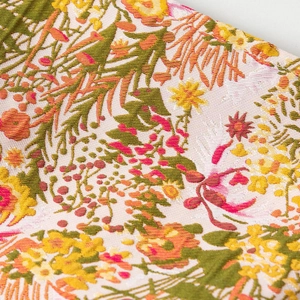 Detail of floral jacquard fabric on the makeup bag with embossed flower texture