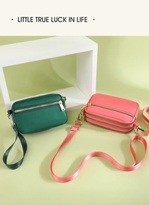 Detail of compact crossbody bags with three zipper compartments and adjustable straps