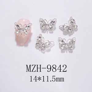 Macro view of 3D hollow butterfly nail art charms with silver alloy and clear rhinestones