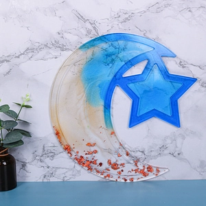Detail of star and moon resin tray with blue amber swirl and gold foil flakes