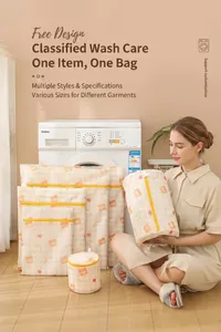 Detail of multi-size mesh laundry bags with bear print and yellow zipper on wood floor