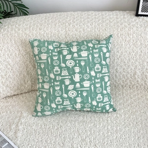 Detail of green cotton linen pillowcase with white kitchen utensils and jam motifs