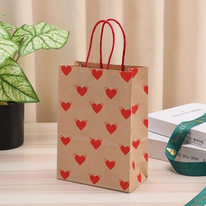 Brown kraft paper gift bag with red winged hearts and sturdy rope handles for Valentine