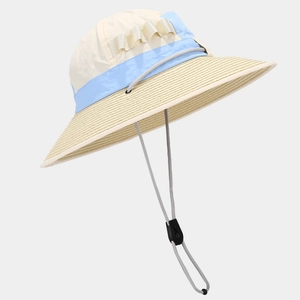 Close-up of color-block wide brim sun hat with woven straw texture and adjustable wind cord
