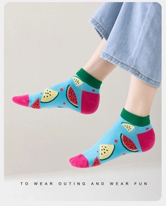 Close-up of low-cut cotton socks featuring a blue base and vibrant watermelon pattern