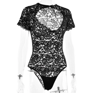 Close-up of black lace bodysuit featuring intricate floral patterns and chest cut-out detail
