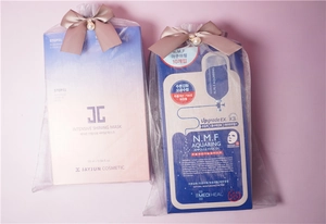 Cosmetic sheet masks displayed inside organza drawstring bags with bow decorations