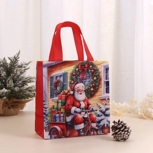Festive Christmas non-woven gift bag with Santa Claus print and sturdy red handles
