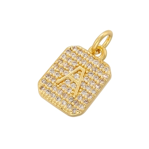 Macro shot of gold square pendant with letter A and micro-paved cubic zirconia stones