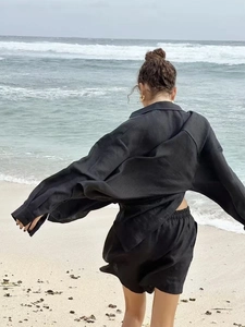 Outdoor shot showing the breathable linen texture and drape of this black two-piece casual set
