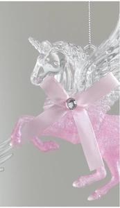 Macro shot of glittery pink unicorn ornament with clear wings and a satin bow detail