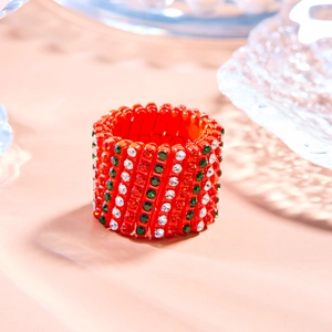 Detail view of red base telescopic magic ring bracelet with colorful rhinestone patterns