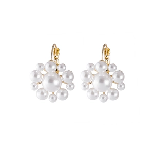 Detail of floral pearl earrings with gold hooks and clusters of white round pearls