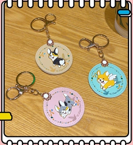 Detailed view of three colorful Corgi dog PU leather round keychains on wood texture