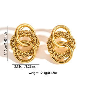 Detailed view of gold titanium steel interlocking hoop earrings with textured bead accents