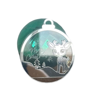 Detailed view of silver metal Christmas charm with reindeer and Merry Christmas engraving
