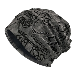Distressed grey street style slouchy beanie with ripped details and graffiti prints