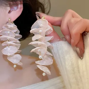 Detailed view of elegant chiffon flower earrings with pearls and long tassel fringe