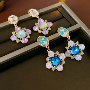 Detailed view of French vintage floral earrings with colorful crystals and cameo design