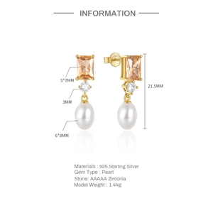 Detail of S925 silver earrings with orange zircon and white teardrop pearl drop