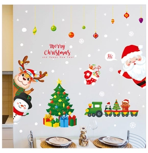 Detailed view of festive Christmas wall stickers with Santa, reindeer and train on a white wall