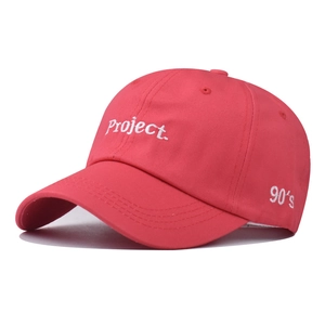 Close-up of pink cotton baseball cap with white Project and 90s embroidery details