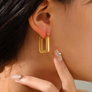 Minimalist 18K gold stainless steel hollow rectangle earrings worn by a model