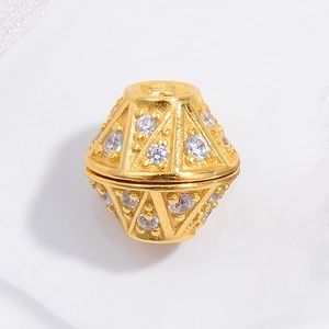 Macro detail of a gold-plated geometric bead with cubic zirconia for jewelry making