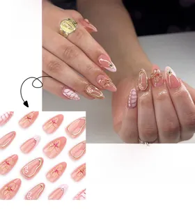 Detail of pink almond-shaped press-on nails with 3D floral accents and gold embossing