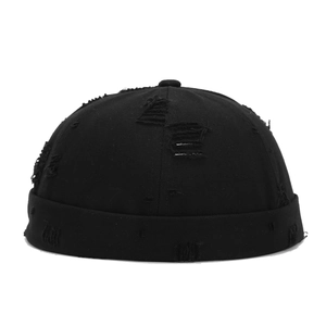 Front view of a black distressed docker hat with vintage frayed holes and rolled brim edge