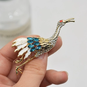 Elegant gold crane bird brooch with blue and white crystals for suit lapel decoration