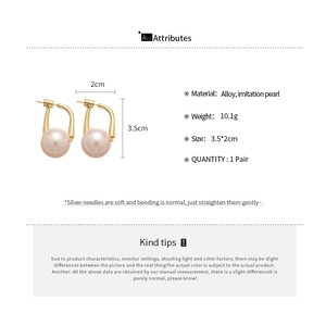Detailed view of large pink pearls on gold-tone alloy earrings with dimensions and weight