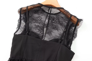Detail of black lace patchwork on a sexy camisole top displayed on a wooden hanger