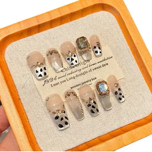 Handmade leopard cat-eye press-on nails with luxury gems and champagne stones in long coffin shape