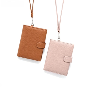 Detail of leather neck passport holders with pebble texture and matching lanyards