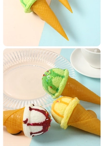 Detailed view of artificial ice cream fridge magnets with colorful toppings and waffle cones