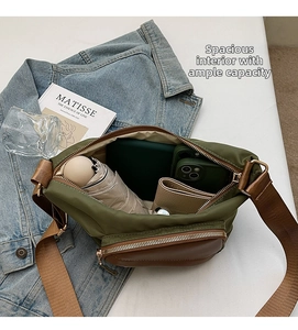 Spacious interior of army green nylon crossbody bag with umbrella and accessories